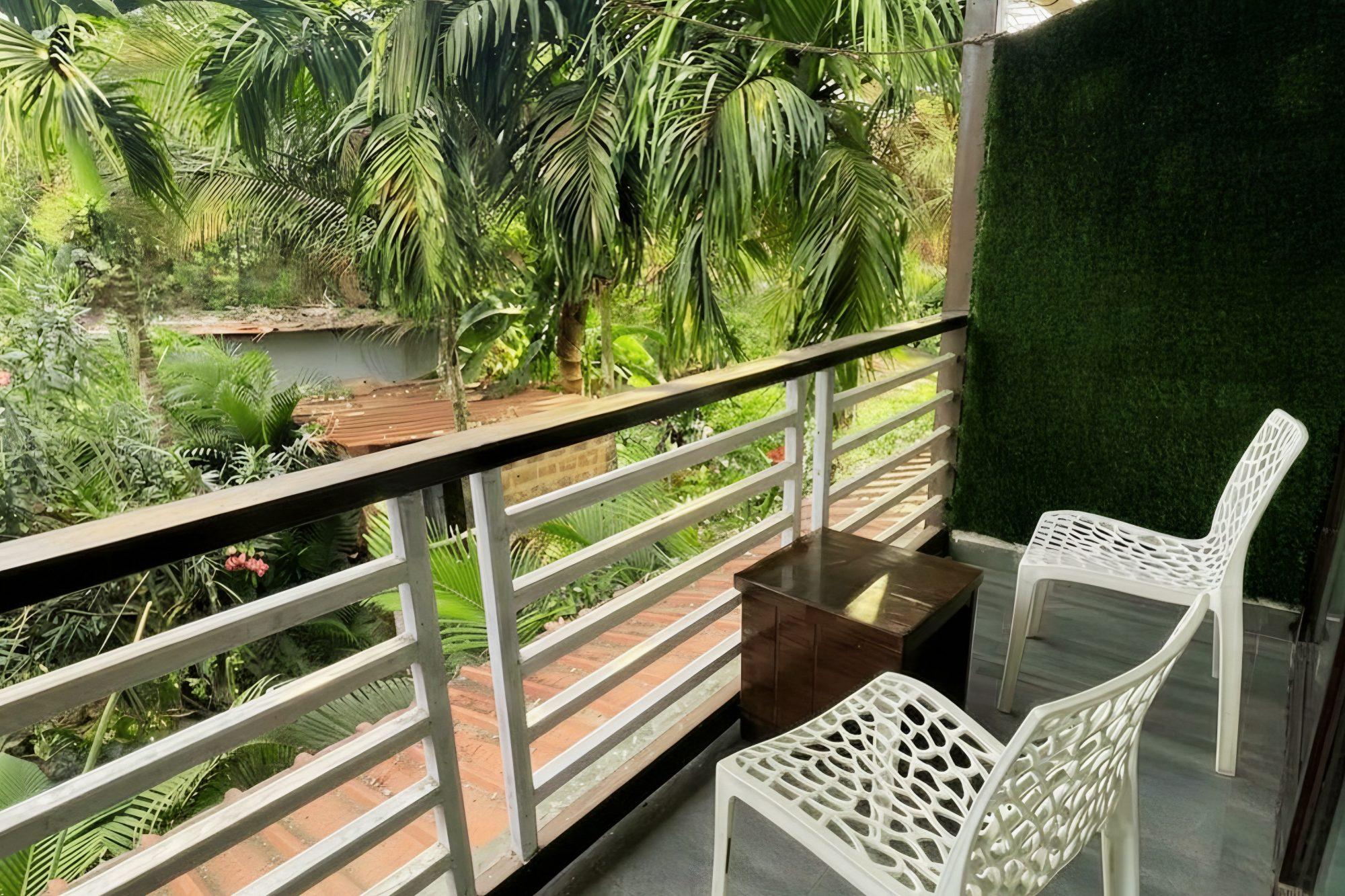 A balcony among the palms at YogiTree Beach Resort & Cafe